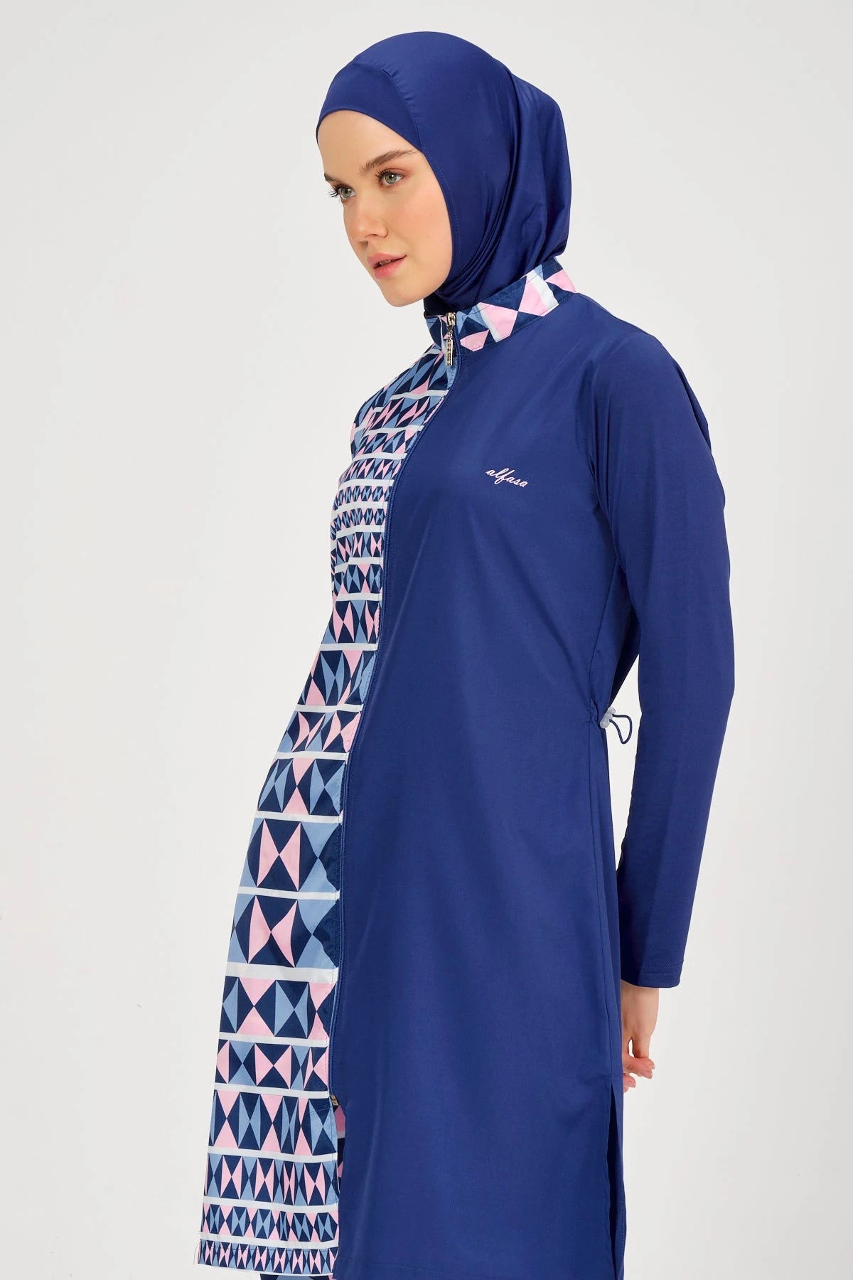 Model in blue burkini and hijab side profile.