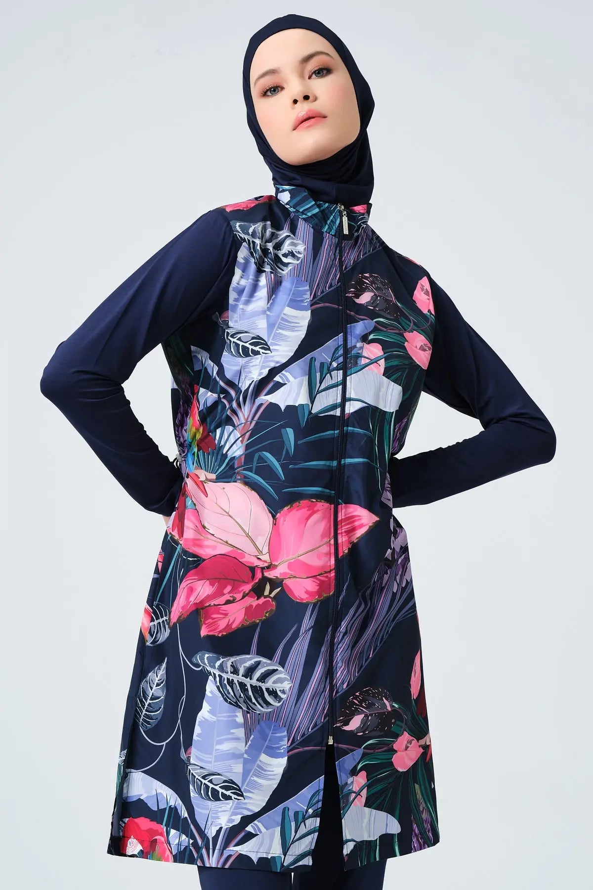 Model wearing navy blue burkini with tropical floral print and hijab