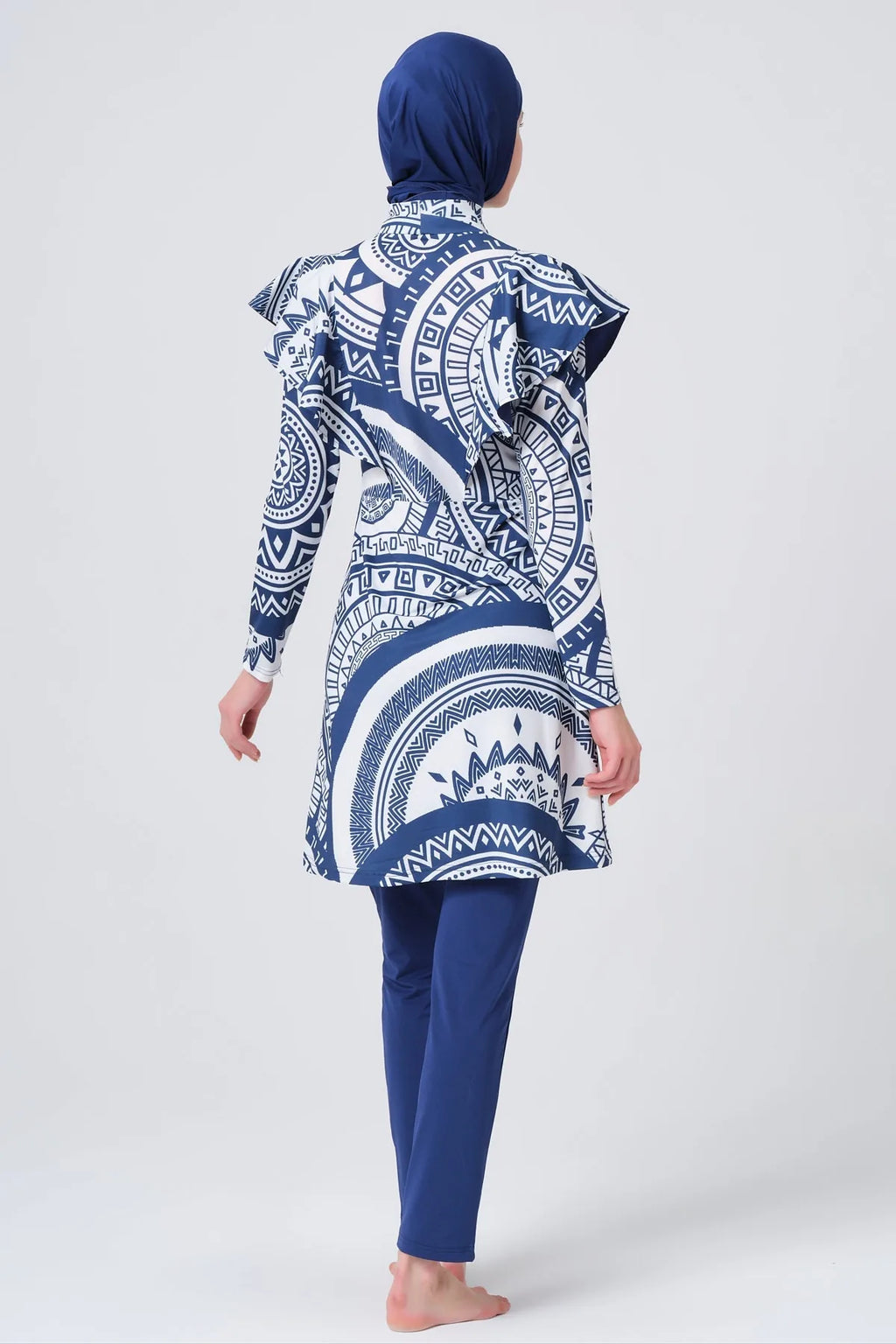 Model in blue and white geometric print burkini back view.