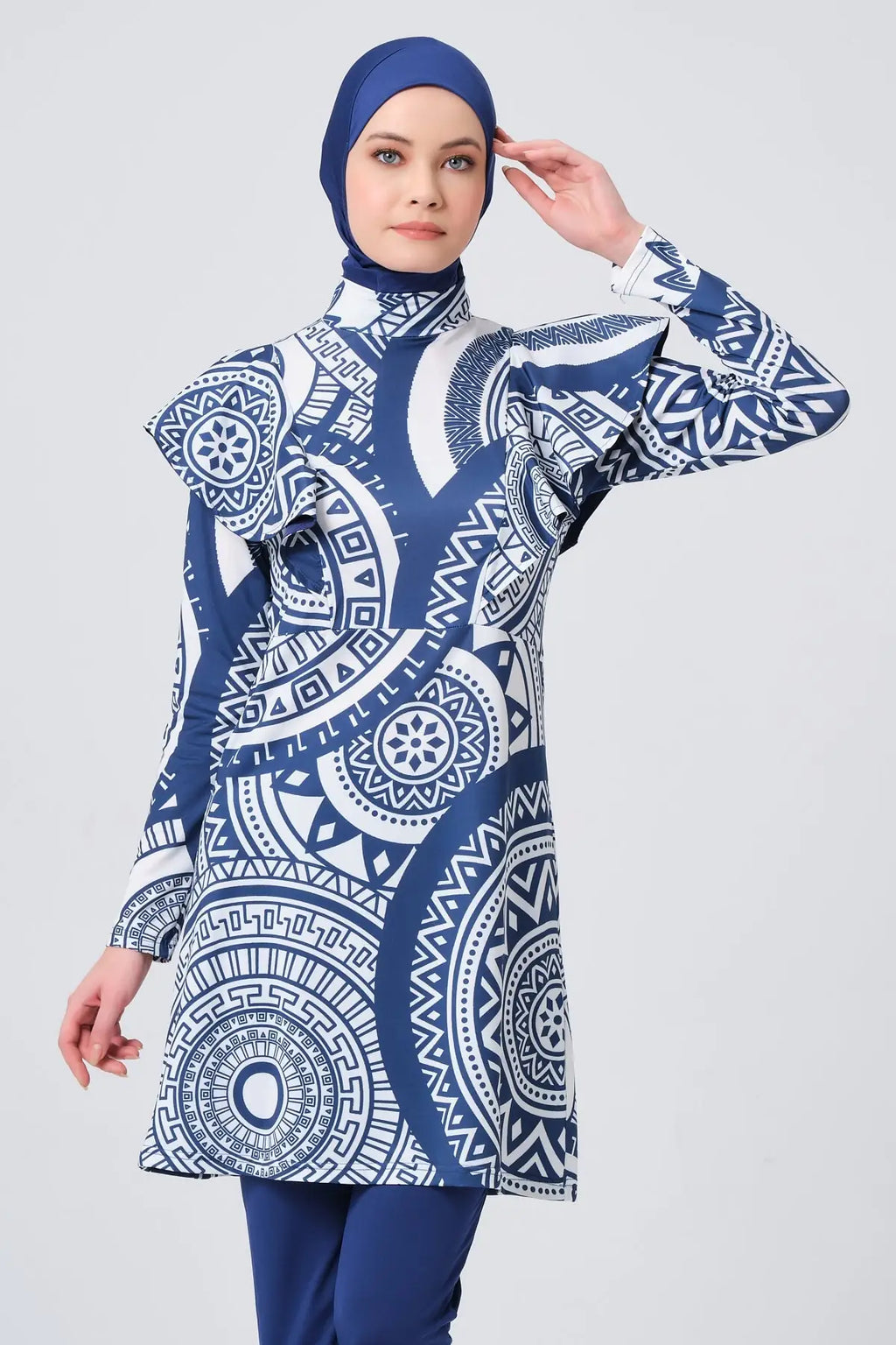 Model in blue and white geometric print burkini front pose.