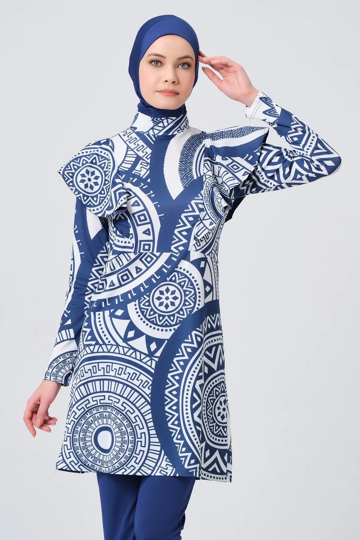 Model in blue and white geometric print burkini front pose.