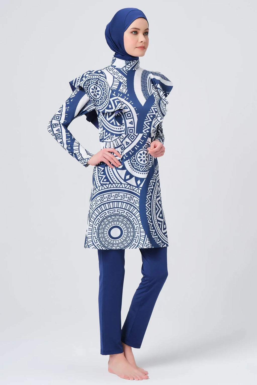 Model in blue and white geometric print burkini side view.