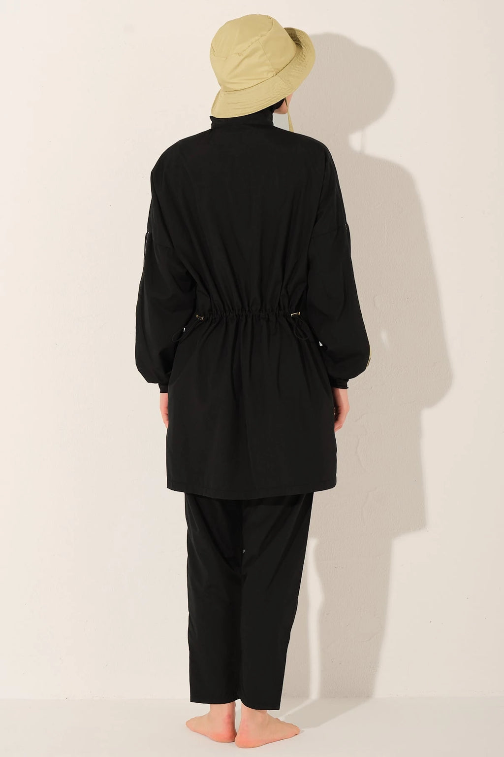 Black burkini set with adjustable drawstring waist and bucket hat, back view.