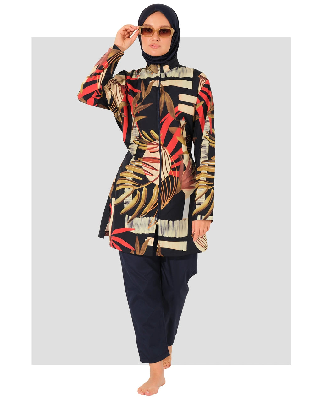 Model in tropical print burkini set, front view, wearing sunglasses.