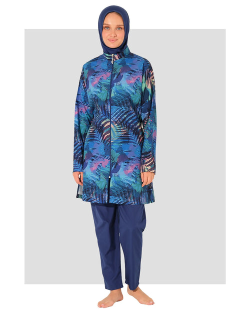 Model wearing blue tropical print burkini set with zipper, front view.