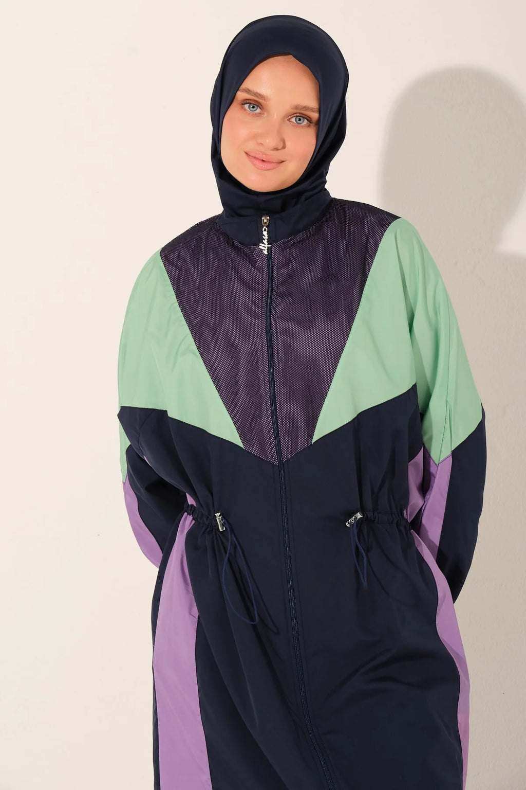 Close-up of Aurora Pulse burkini top and hijab on model.