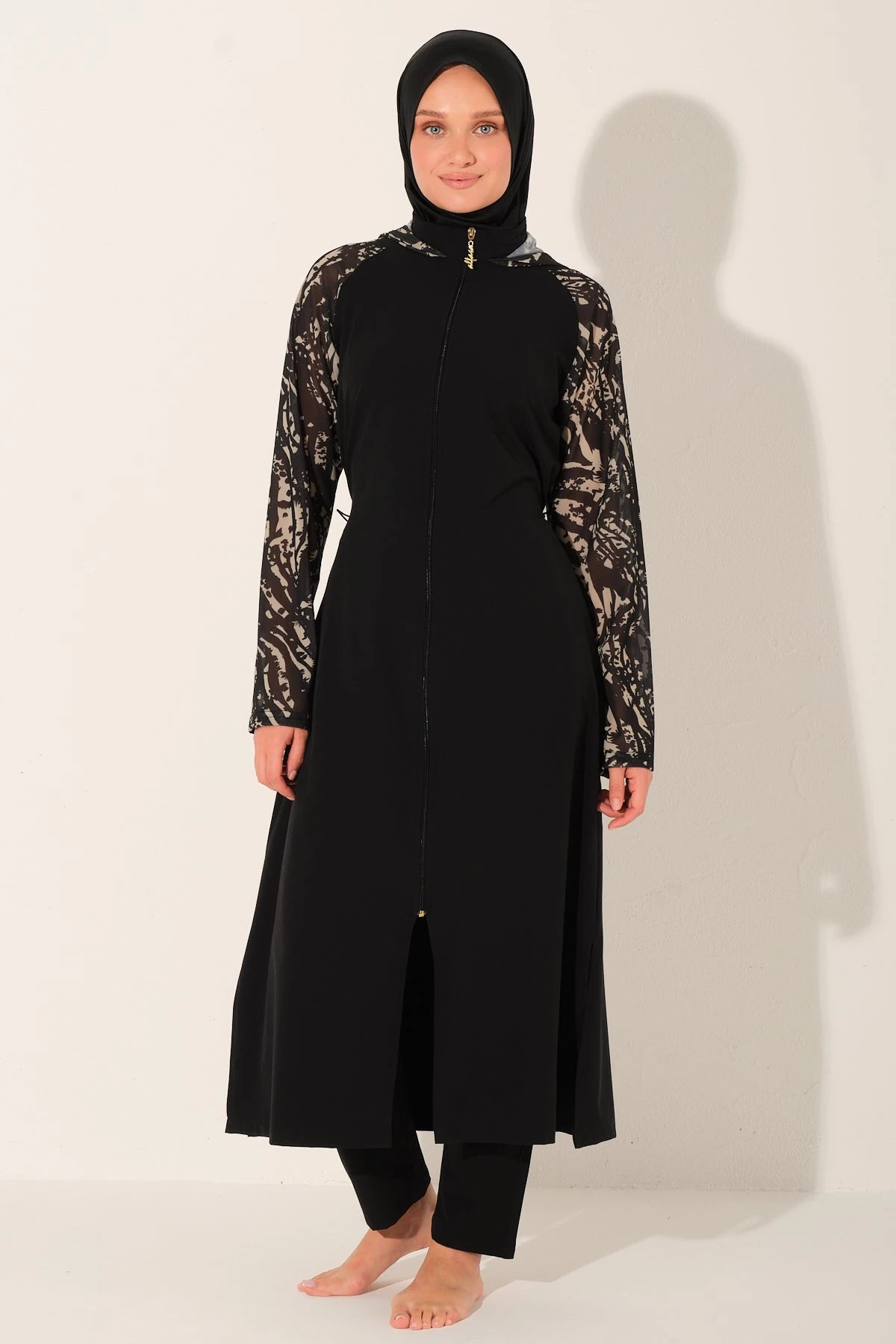 Black burkini set with patterned sleeves, full front view.