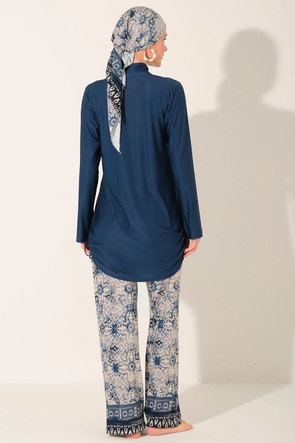 Blue burkini set back view showing full coverage top and patterned pants.