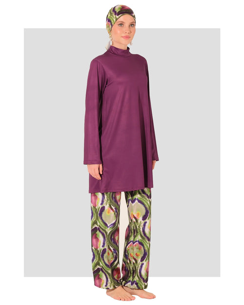 Plum burkini set with abstract peacock print pants and matching headscarf.