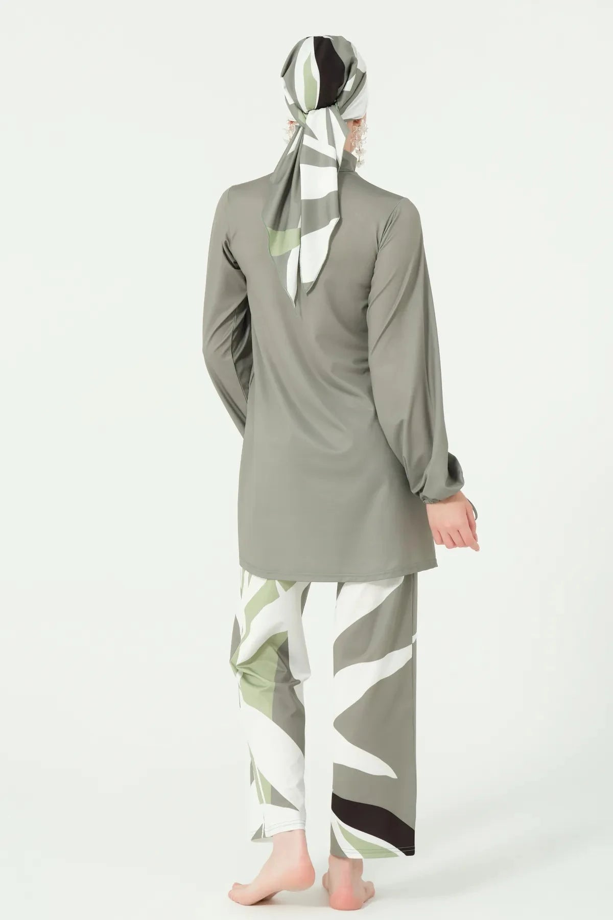Back view of full coverage burkini in olive green and geometric print.