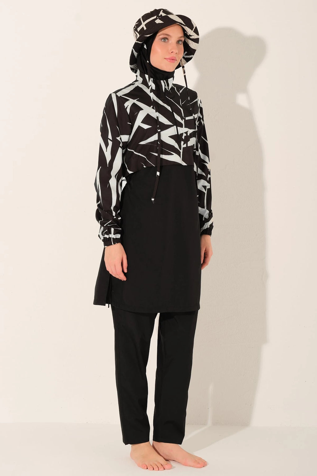 Monochrome burkini set side angle view on model with patterned top.