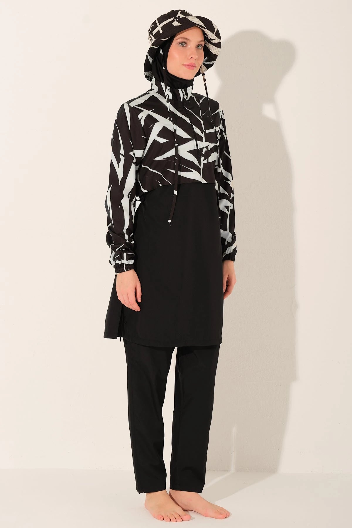 Monochrome burkini set side angle view on model with patterned top.
