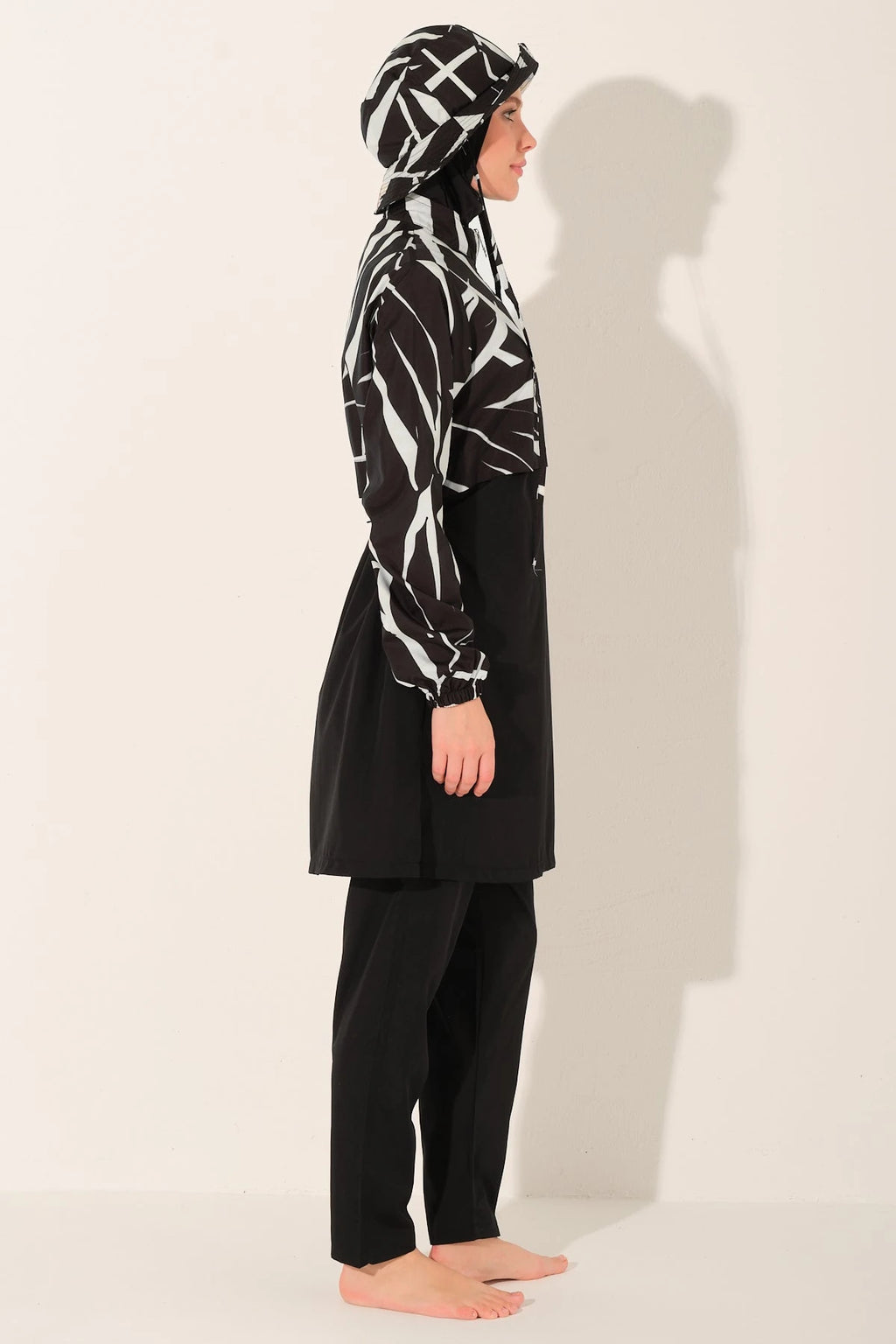 Monochrome burkini set side profile view on model.