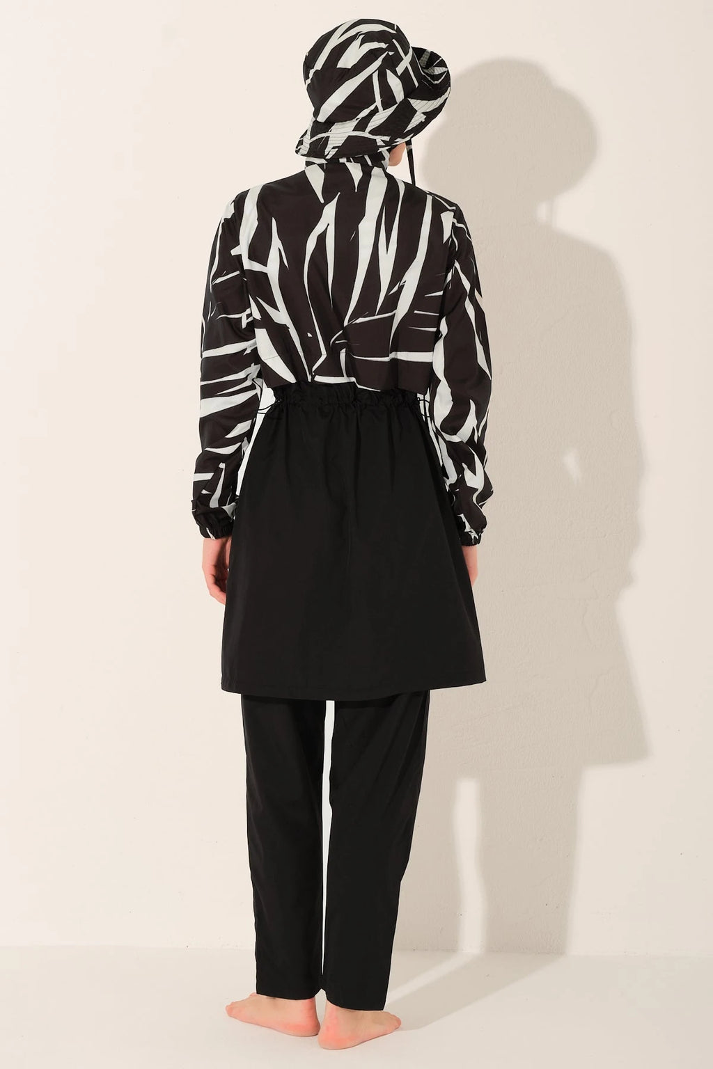 Monochrome burkini set back view on model with patterned top.