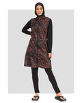 Model in orange and black patterned burkini set, front view, standing.
