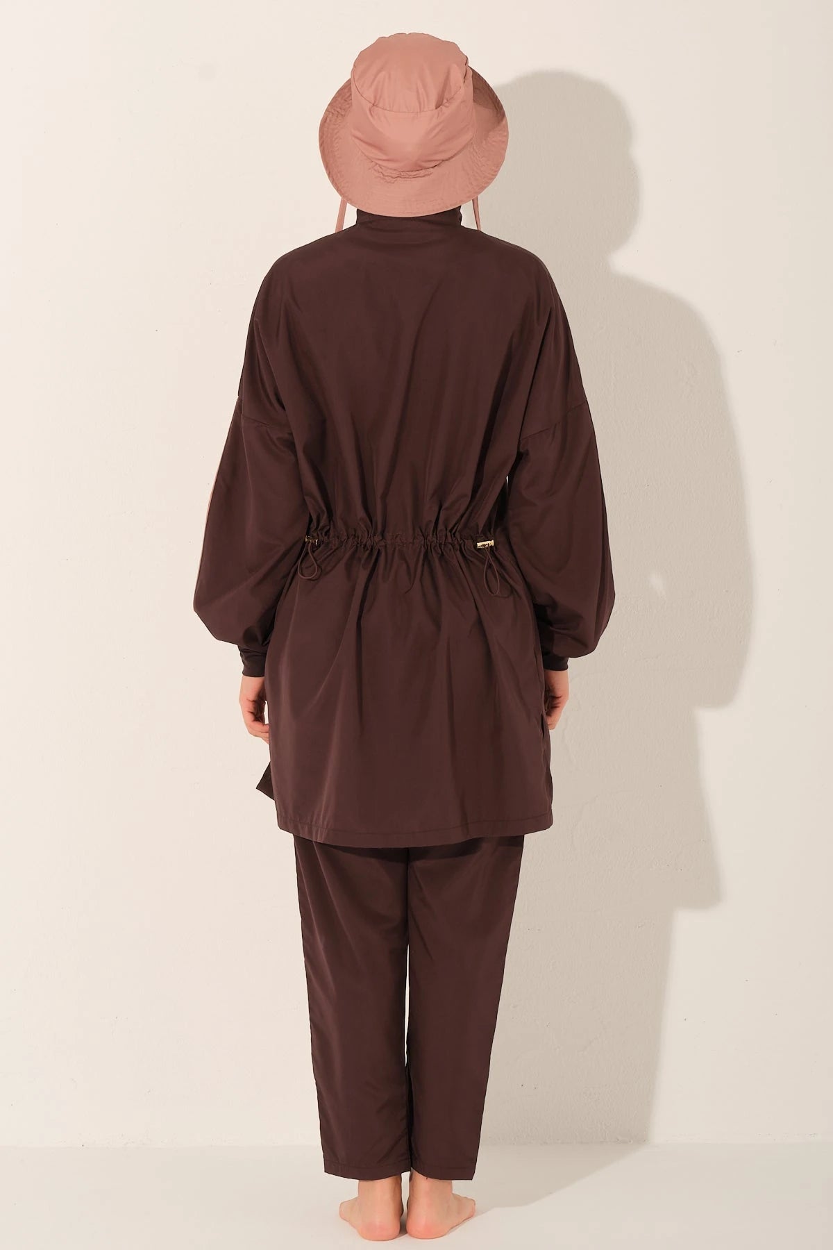 Back view of mocha blush burkini set on model, showing waist detail.