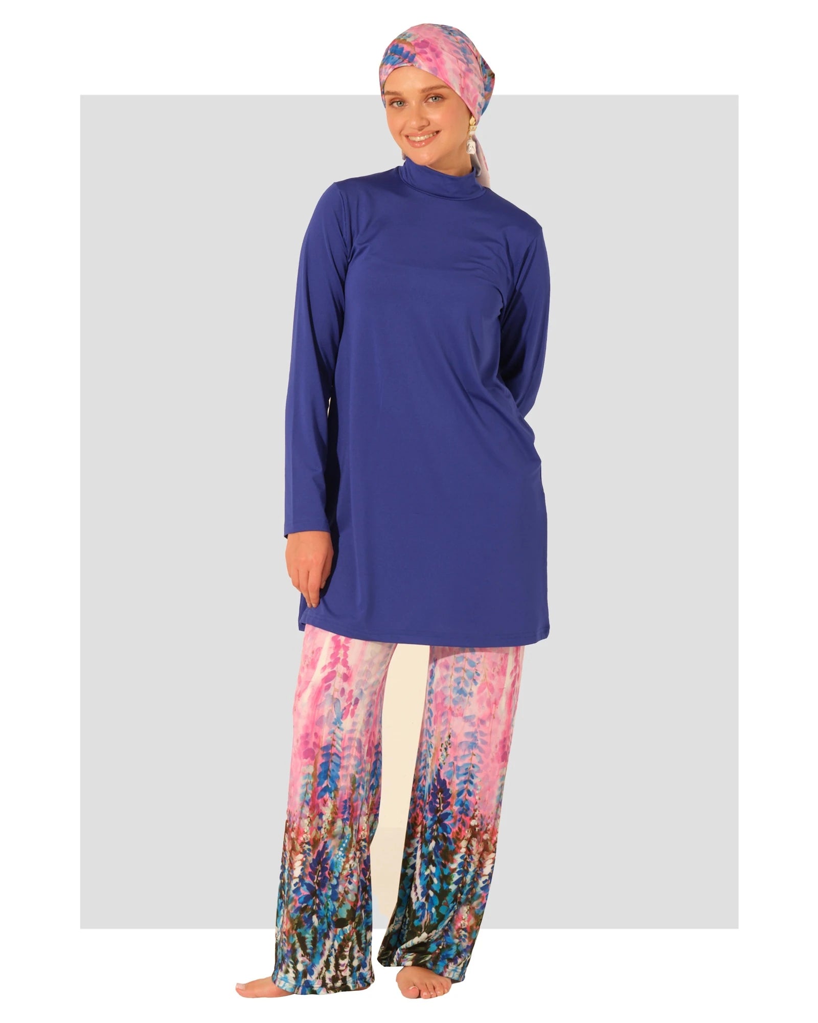 Woman in sapphire blue burkini top and floral print swim pants.