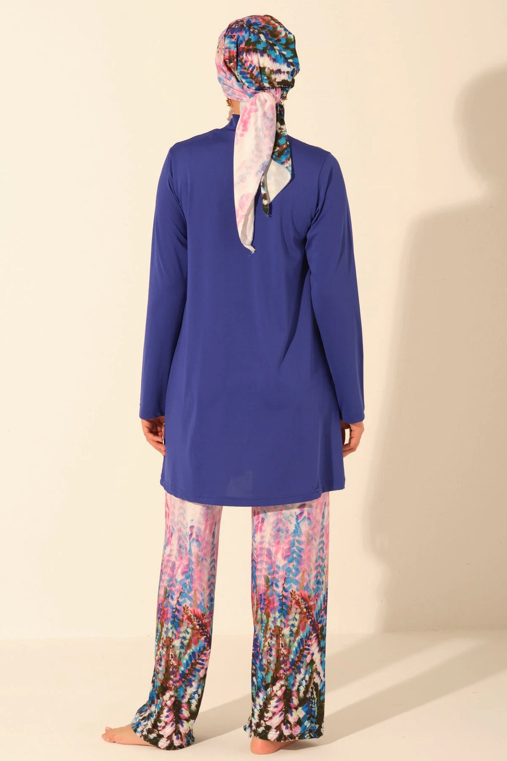Back view of sapphire blue burkini top and floral print pants.