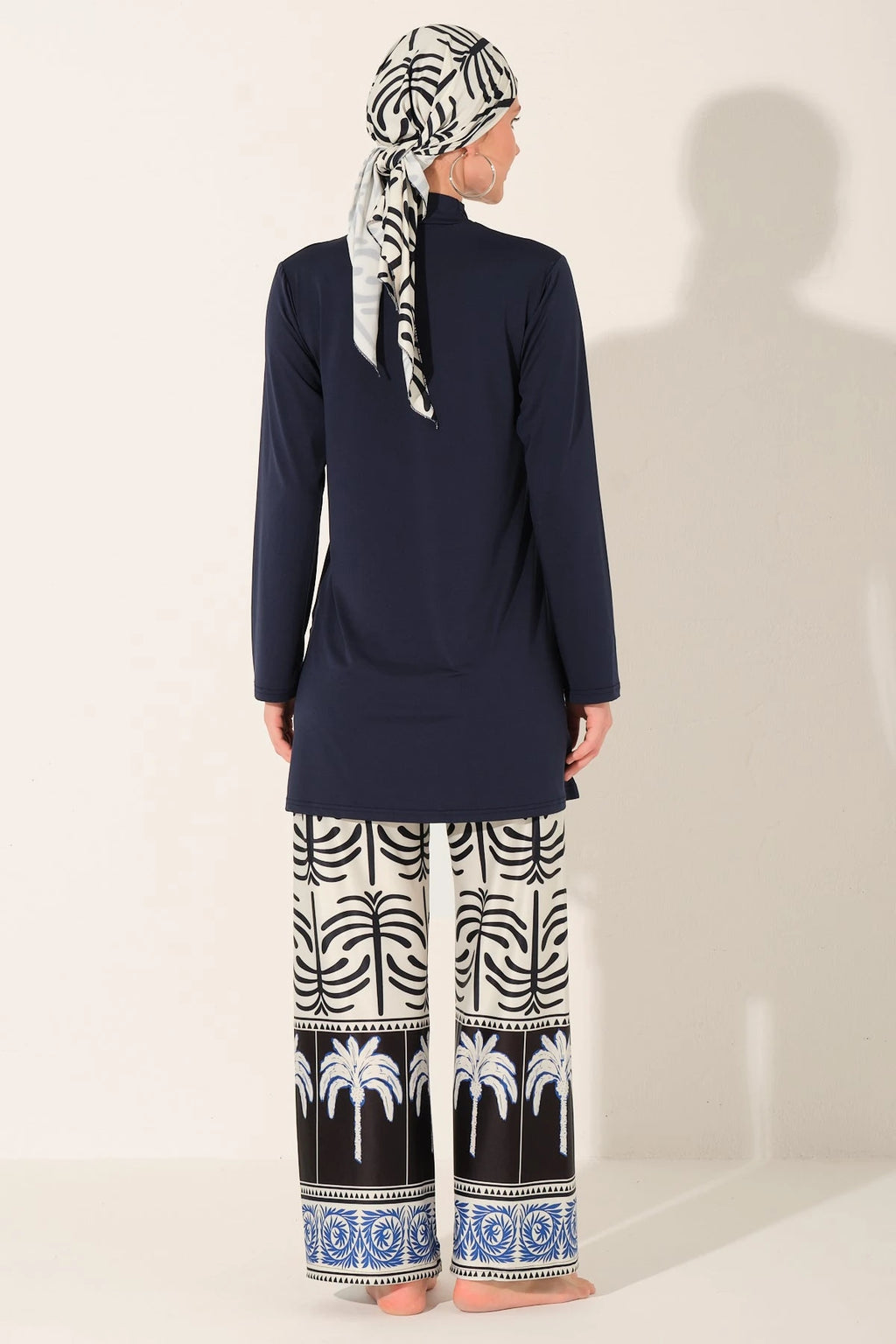 Navy blue burkini set with palm print swim pants back view.