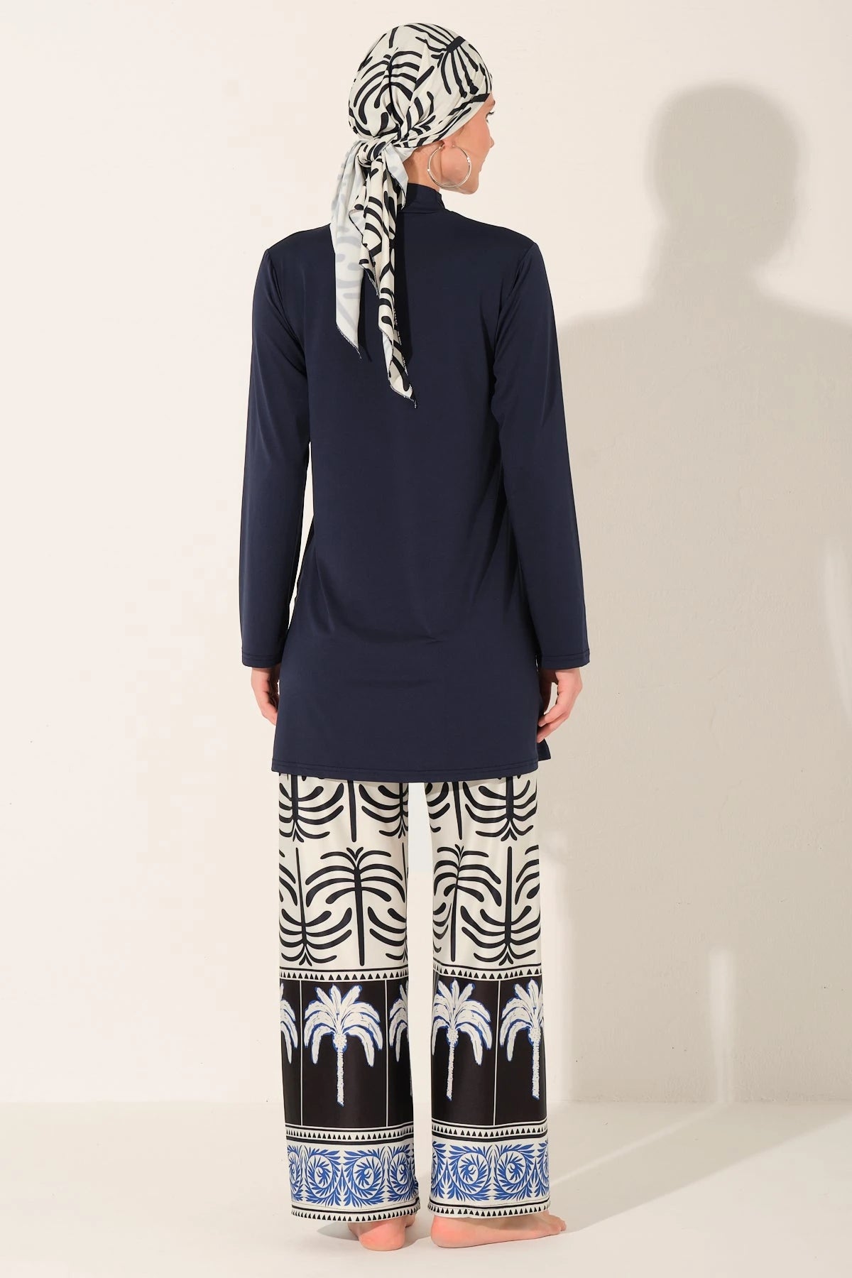 Navy blue burkini set with palm print swim pants back view.
