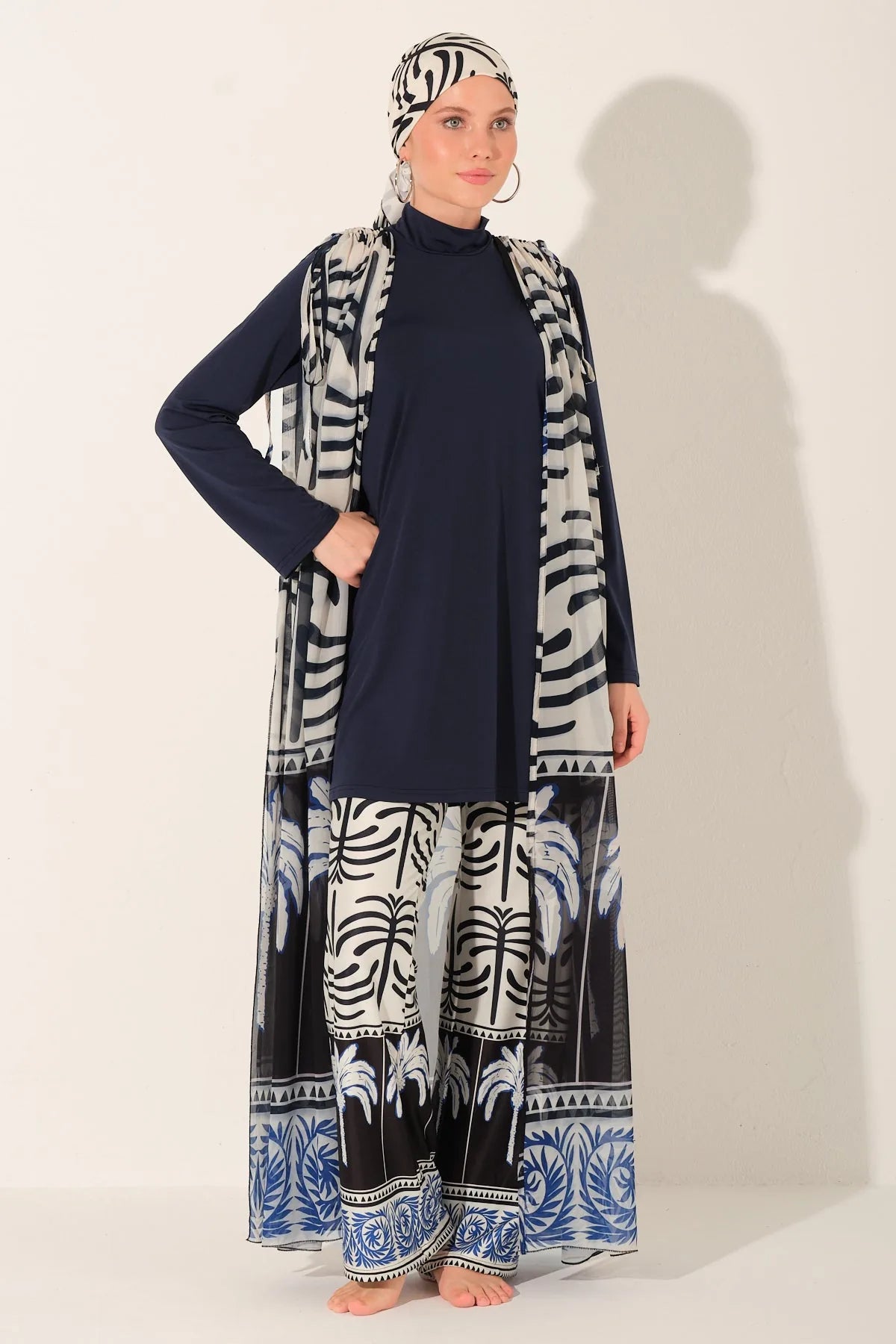 Model in navy blue burkini set with palm print kimono.