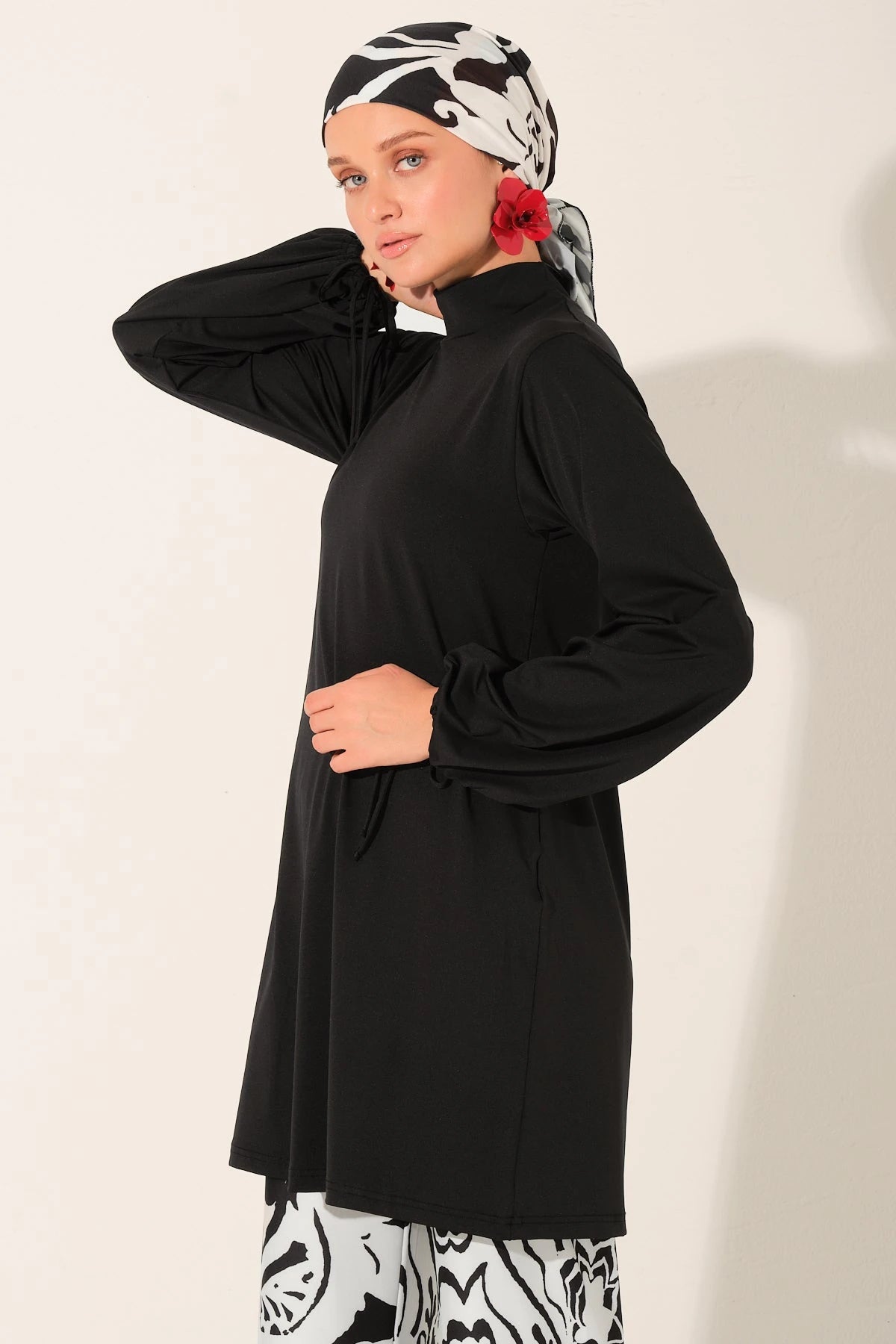 Close-up of black and white burkini top and patterned headscarf.