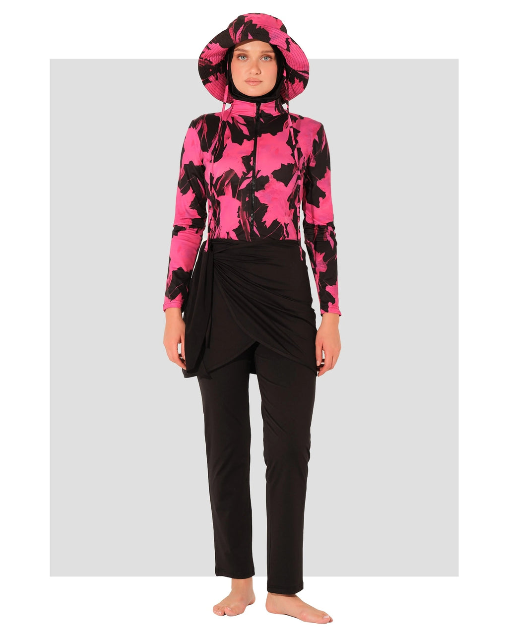 Woman in active floral burkini set with hat, front view.