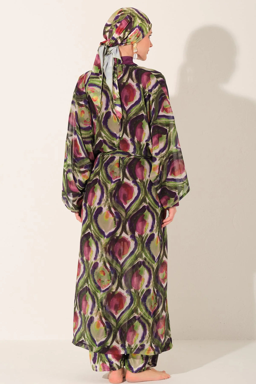 Back view of model in peacock print burkini set with elegant kimono.