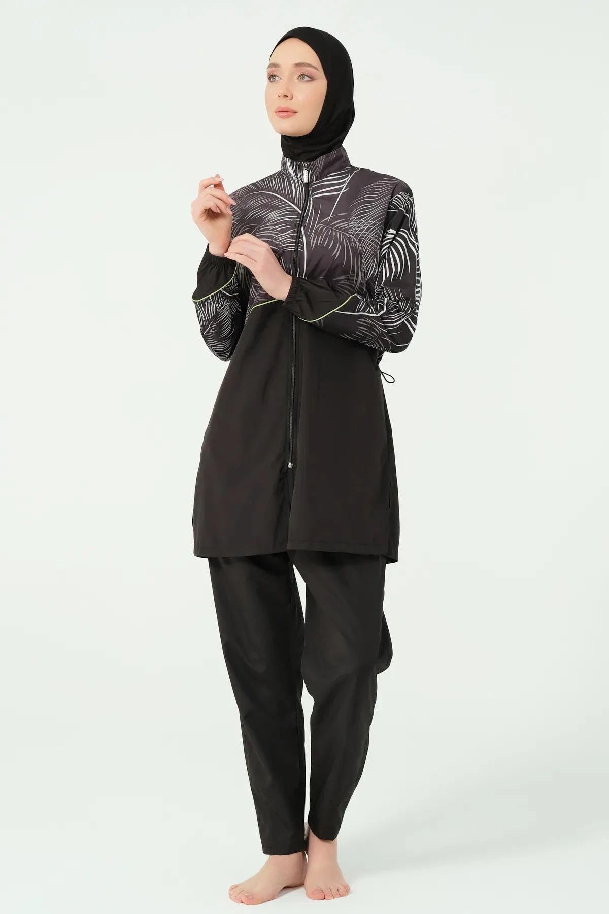 Black burkini with palm print top and zip detail, side pose.
