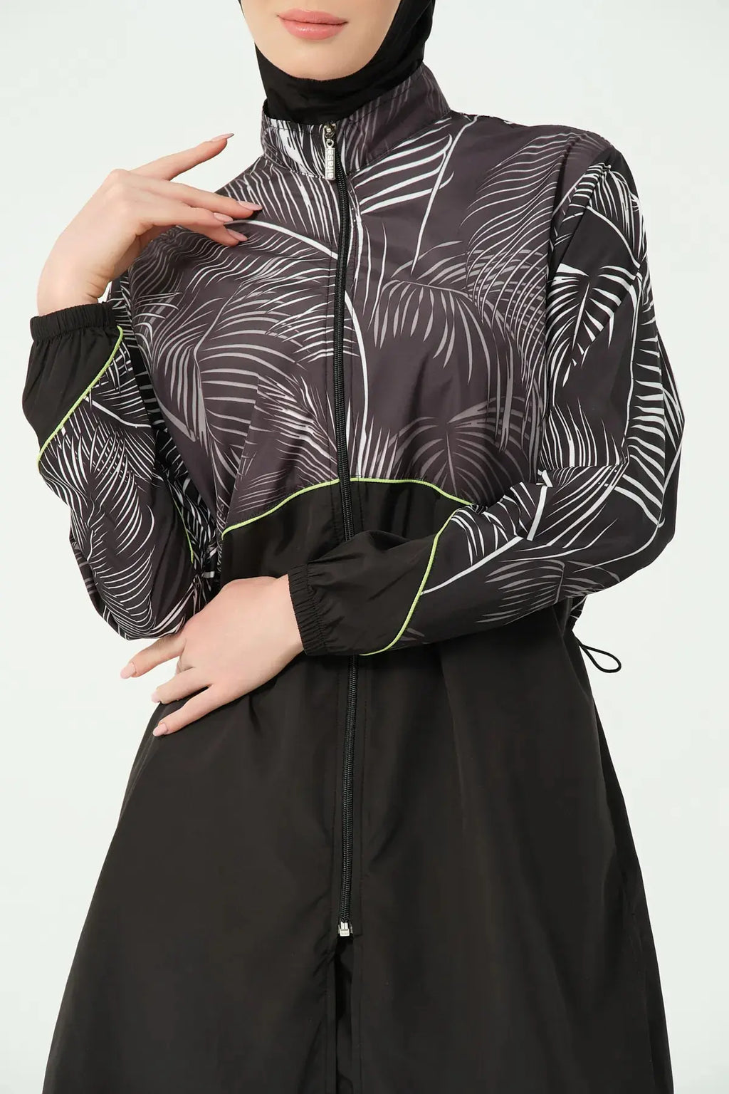 Close-up of burkini top with zip and palm print detail.