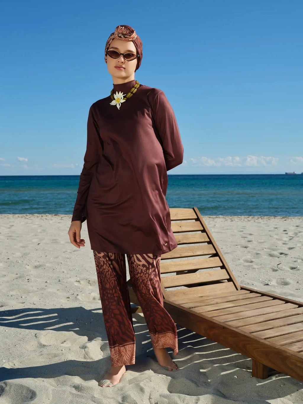 Full view of mocha print burkini with kimono on sunny beach.