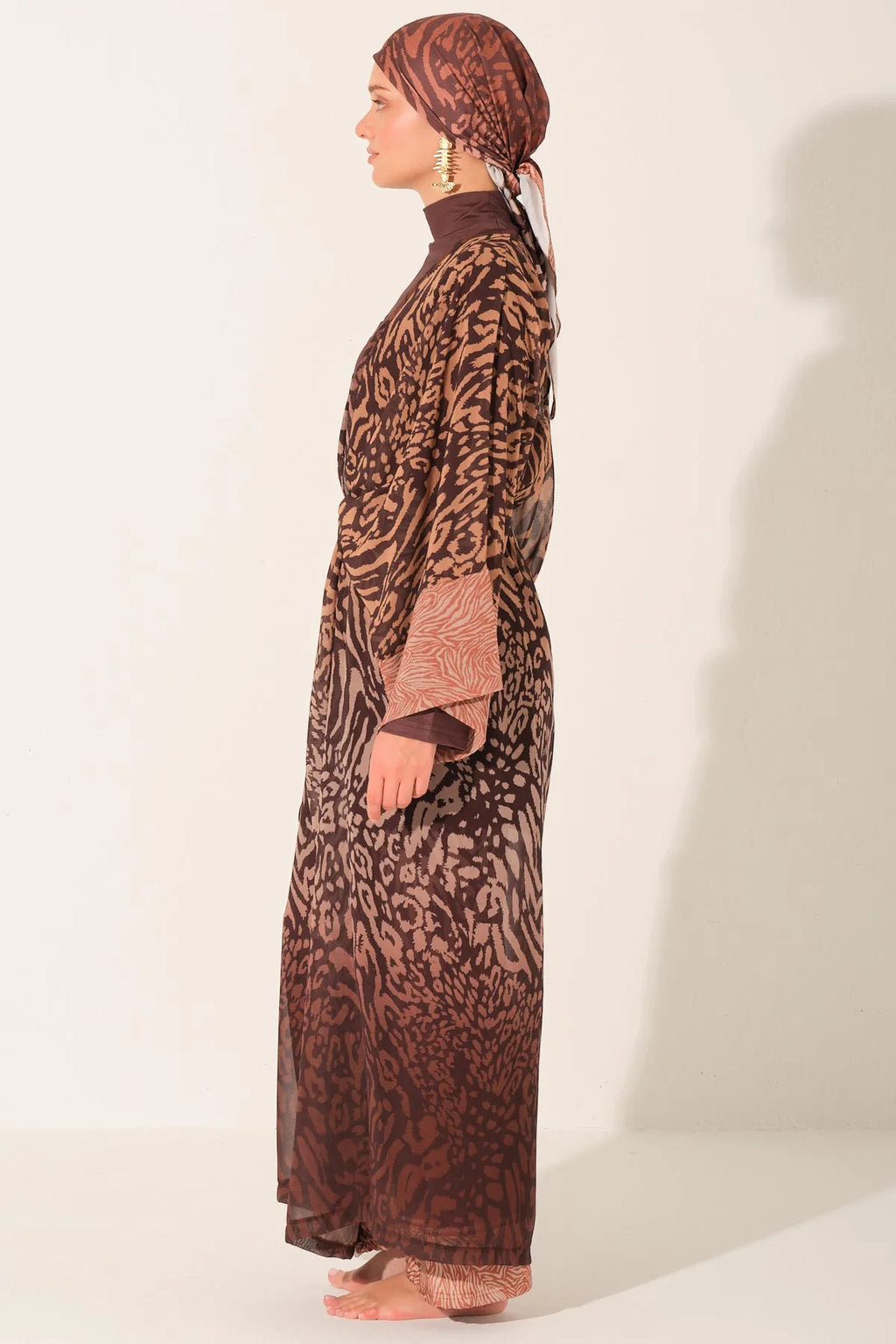 Studio shot of mocha print burkini with open kimono, side view.