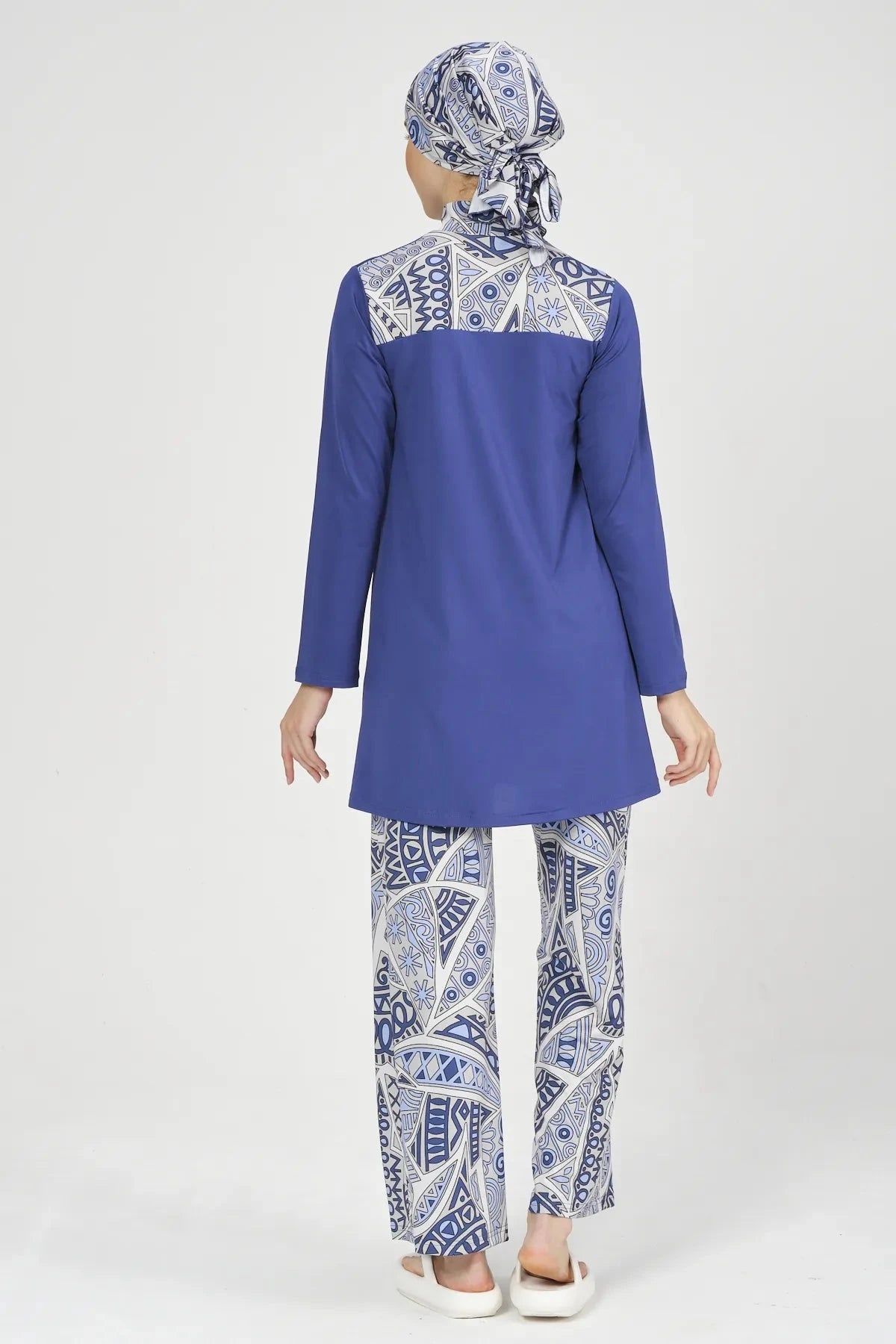 Back view of model wearing blue Lycra burkini with abstract print.