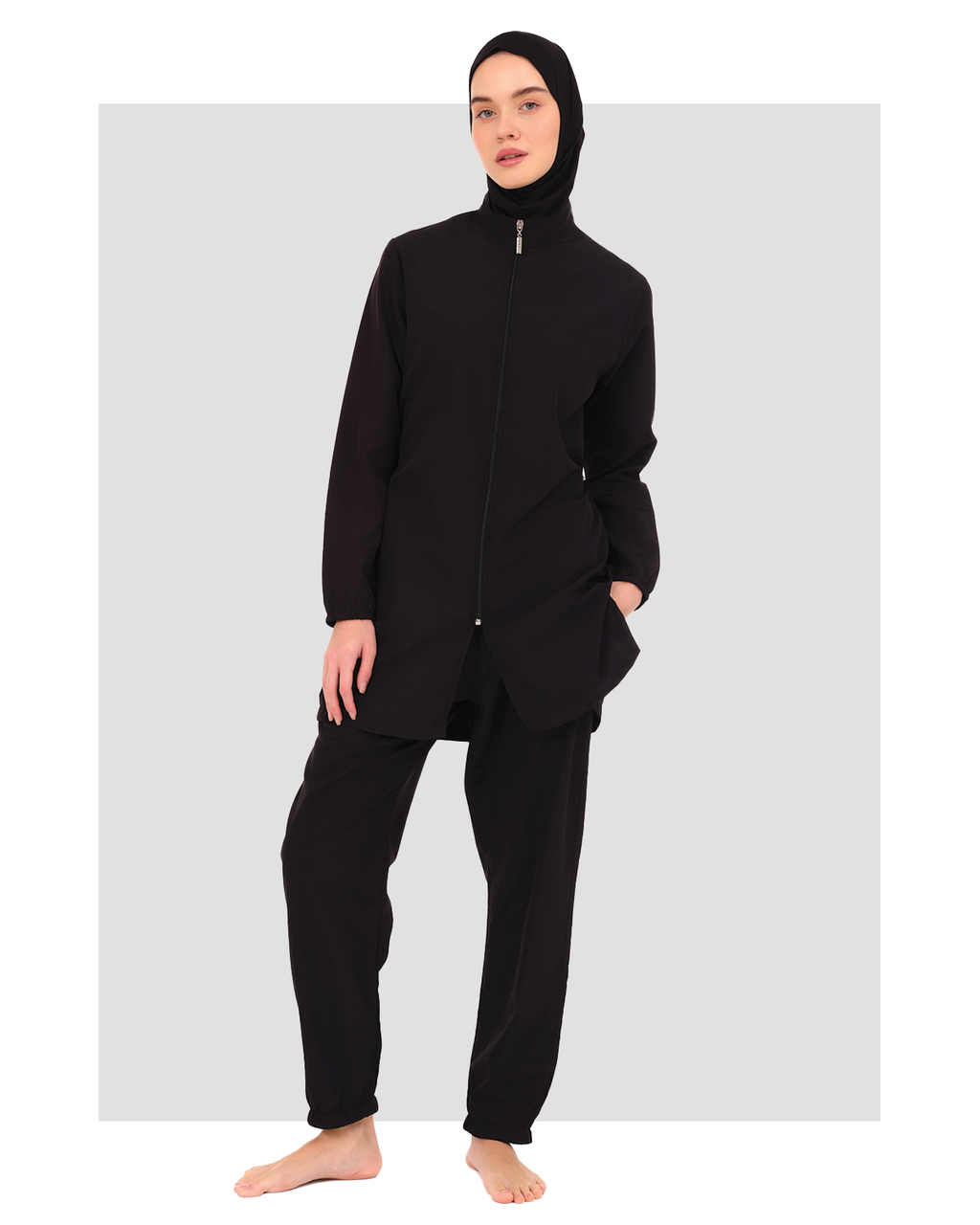 Black burkini set with jogger pants and swim cap, front view.