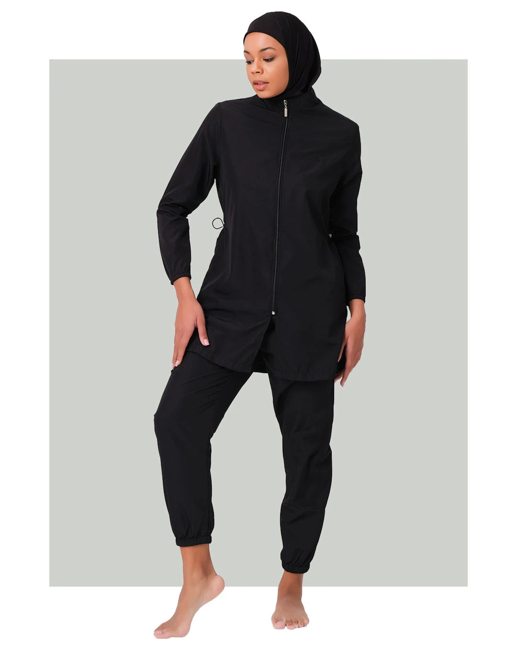 Black burkini set with jogger pants and swim cap, front view.