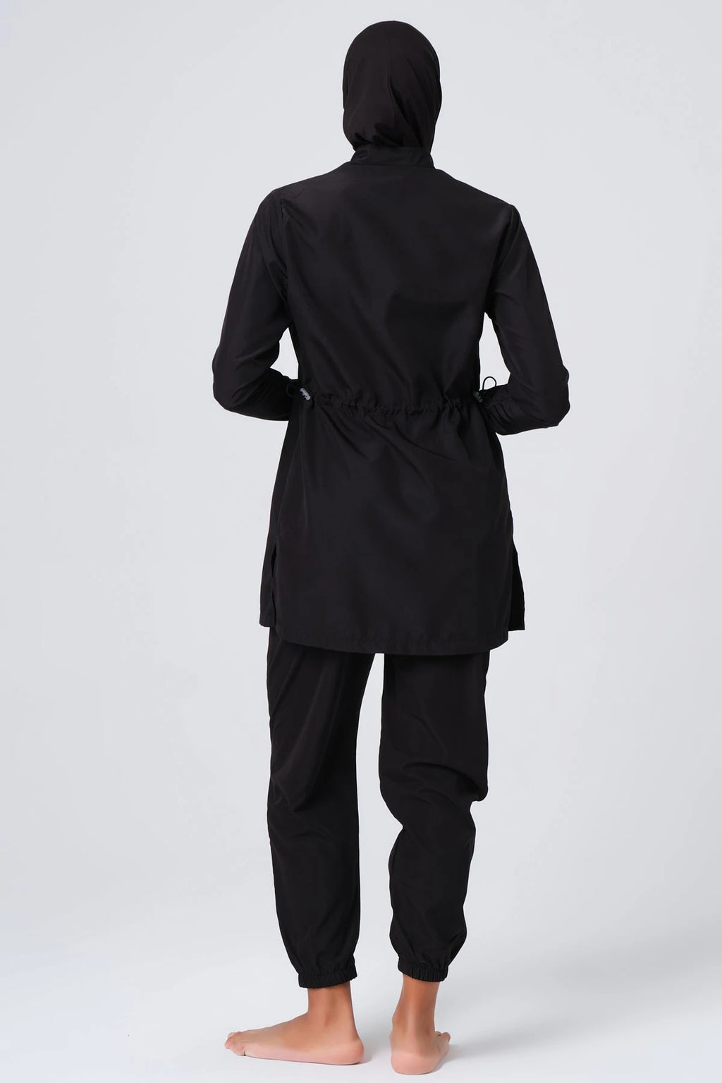 Black burkini set with full-length sleeves and jogger pants, back view.