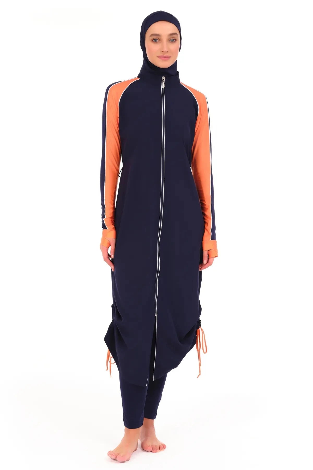 Full navy burkini with orange sleeves and front zipper, standing.