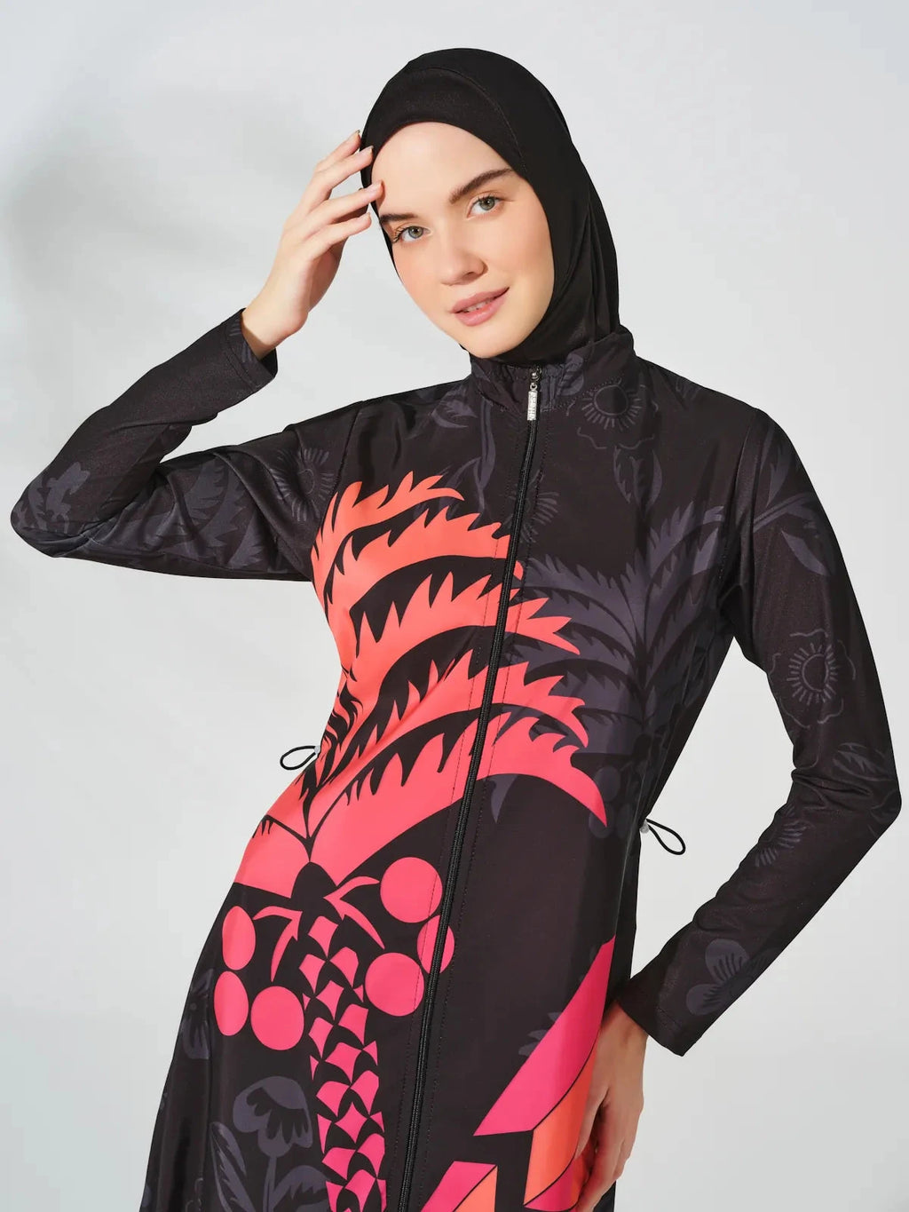 Close-up of the fuchsia graphic print on a burkini with a front zipper detail.