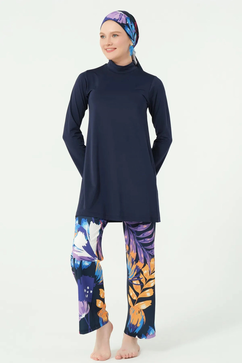 Navy long-sleeve tunic with floral wide-leg swim pants, front view.