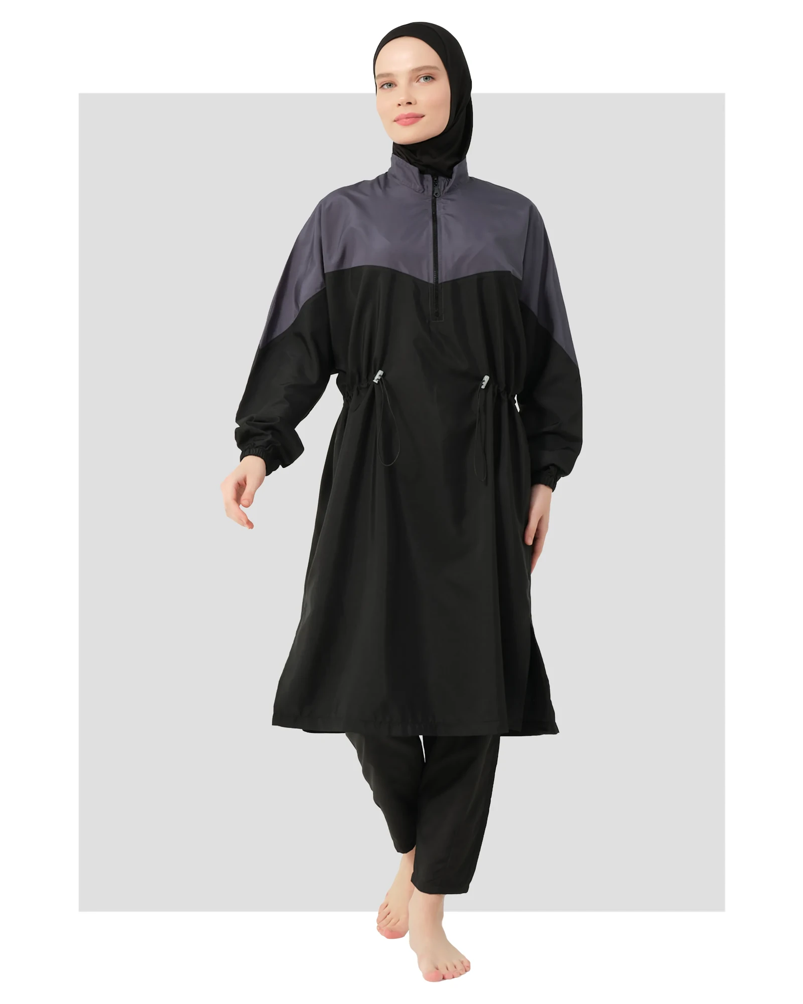 Woman wearing a monochrome burkini set with a black hijab.