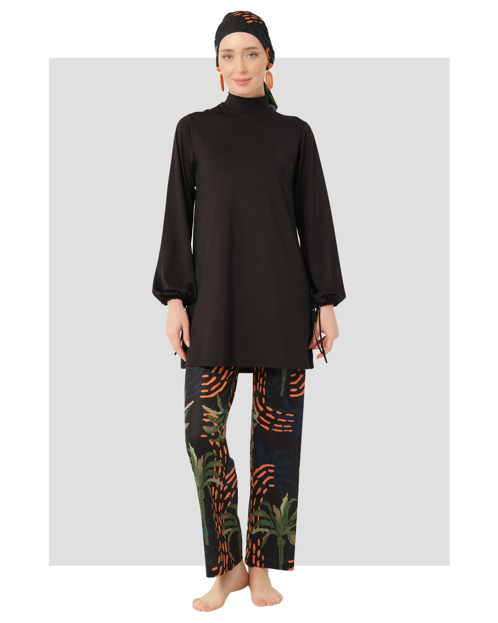 Black burkini set with tropical palm print pants and head covering.