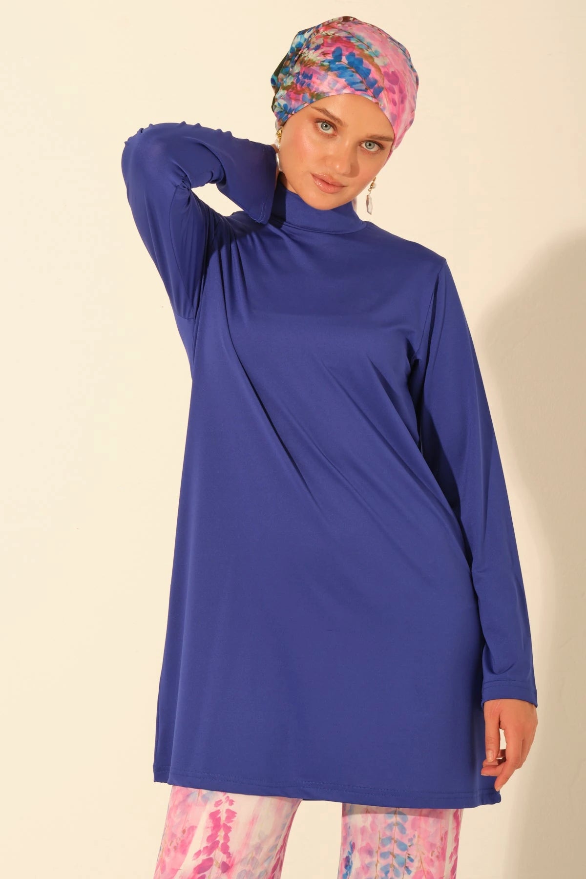 Close-up of model in royal blue burkini top and printed headscarf.