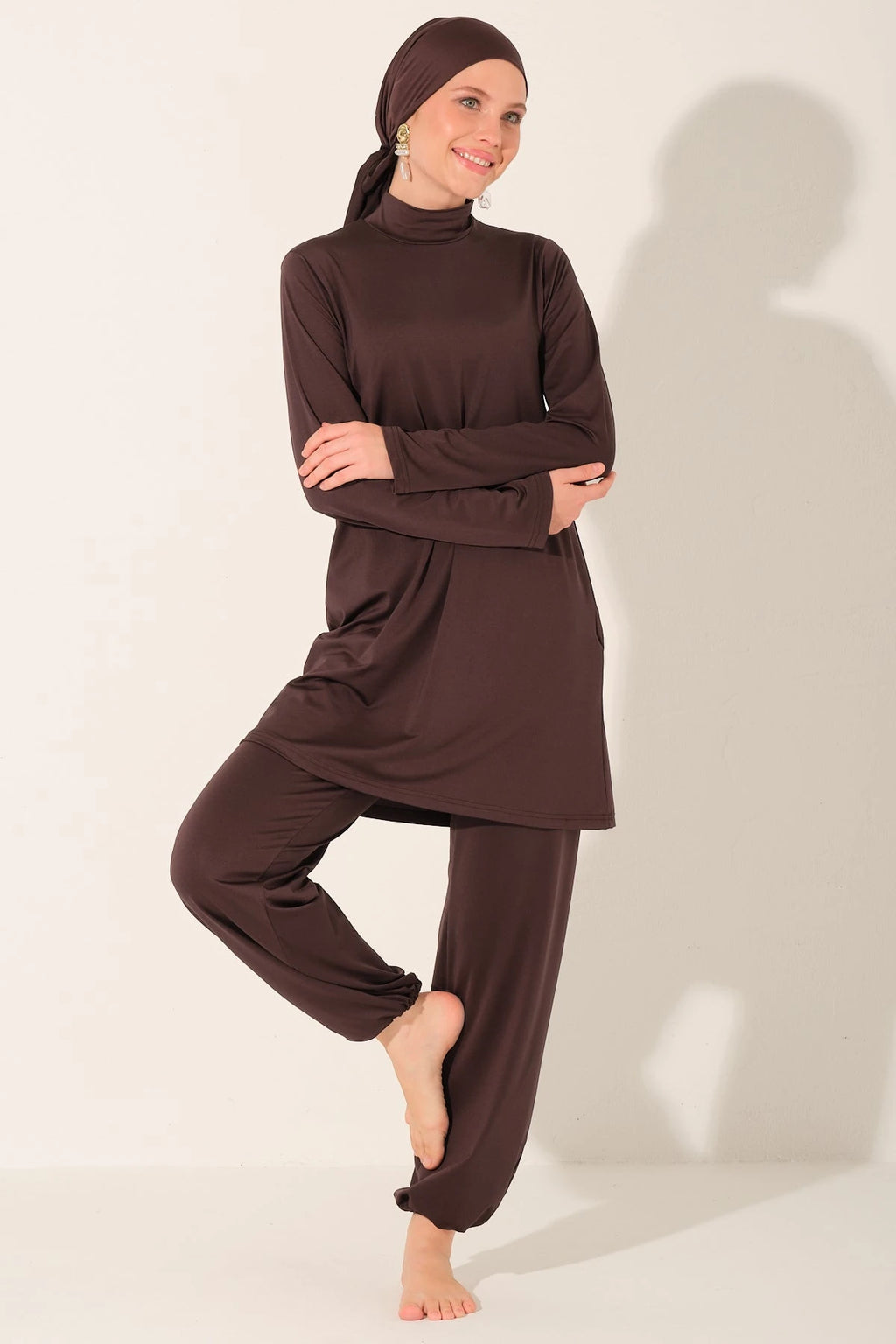 Mocha burkini set on model in a confident pose.