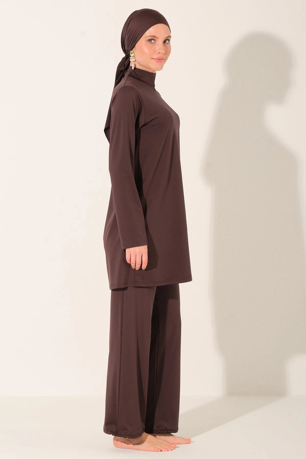 Side view of mocha burkini set on model.