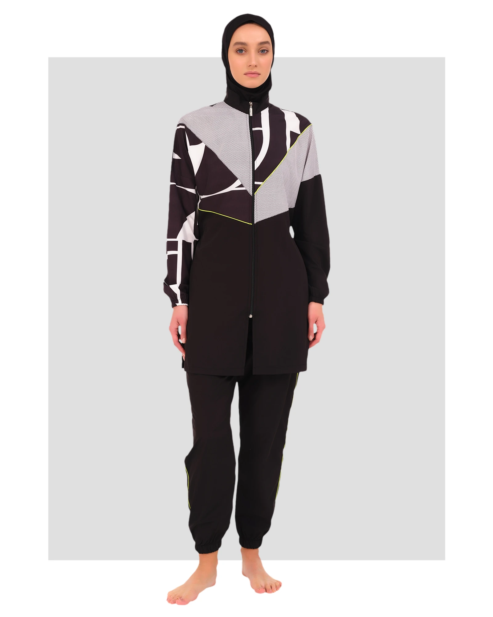 Woman wearing black and grey geometric print burkini front view.