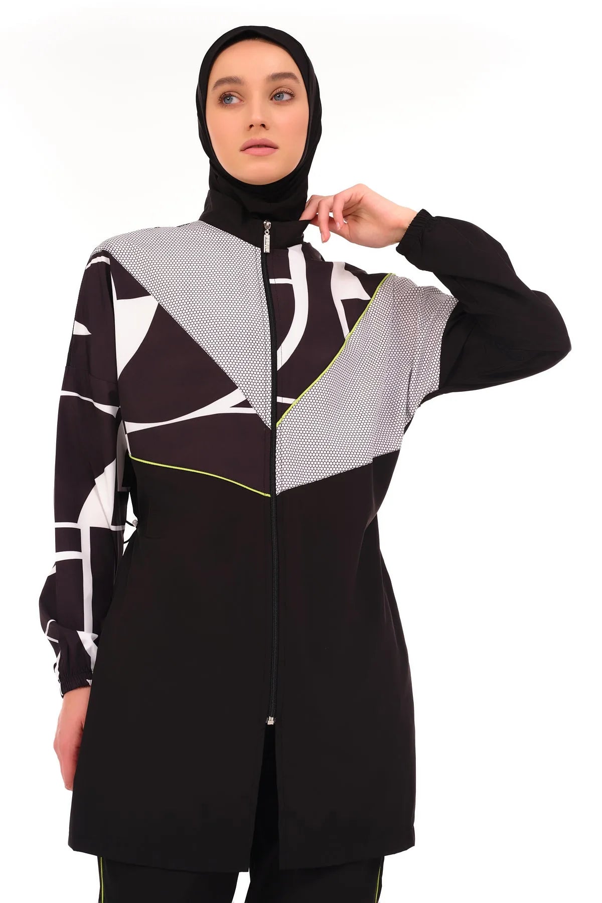 Close-up of woman in geometric print burkini top adjusting collar.