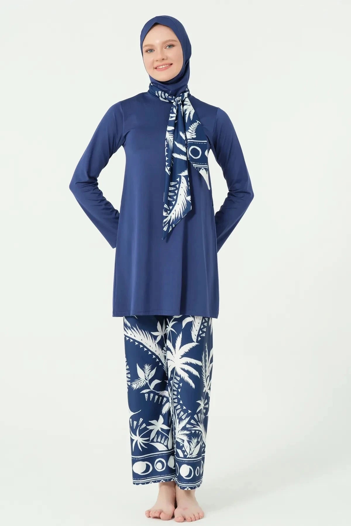 Woman in navy Lycra burkini with white palm print, full set front view.