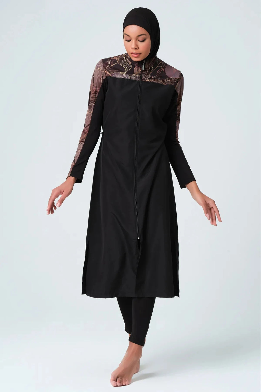 Full body shot of black burkini with patterned sleeves and hijab.