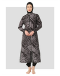 Woman wearing a black and grey abstract print burkini with a hijab.
