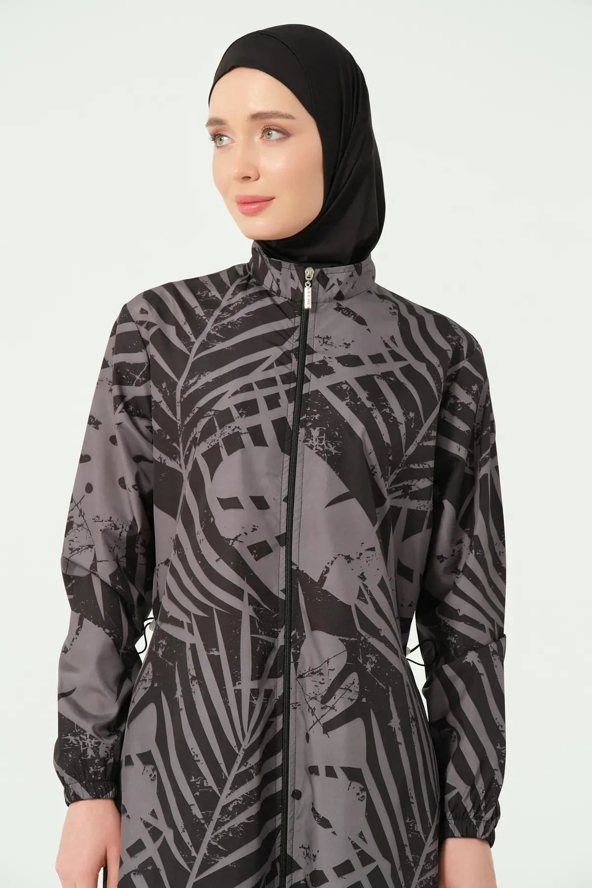 Close-up of the zipper on a black and grey abstract print burkini.